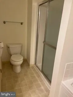 a bathroom with a toilet and a shower