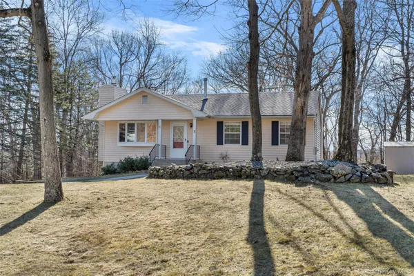 a front view of a house with yard covered with snow