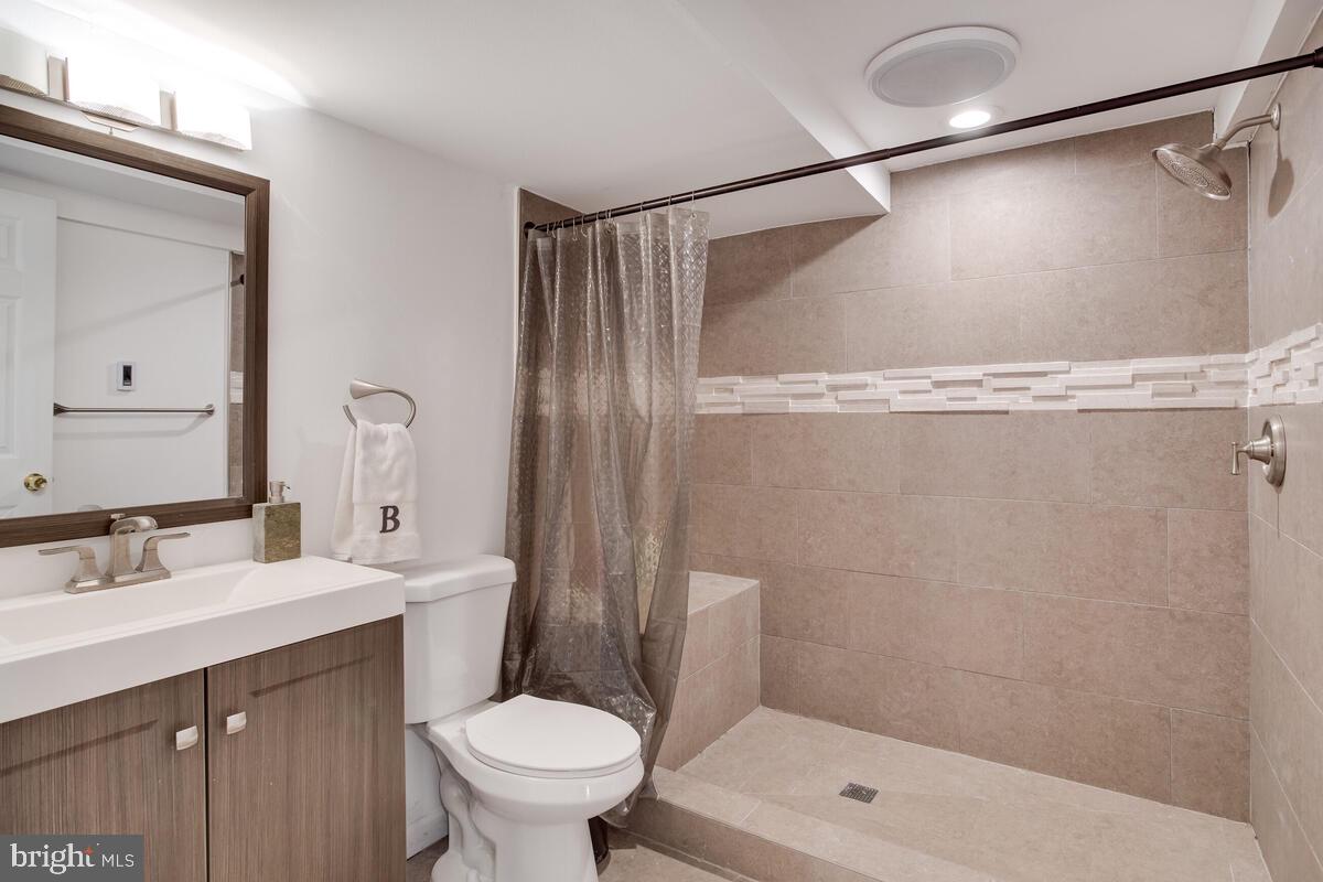 2144 Cedar Road Port Republic, MD 20676 - Photo 45 of 56 a bathroom with a shower sink vanity mirror and toilet