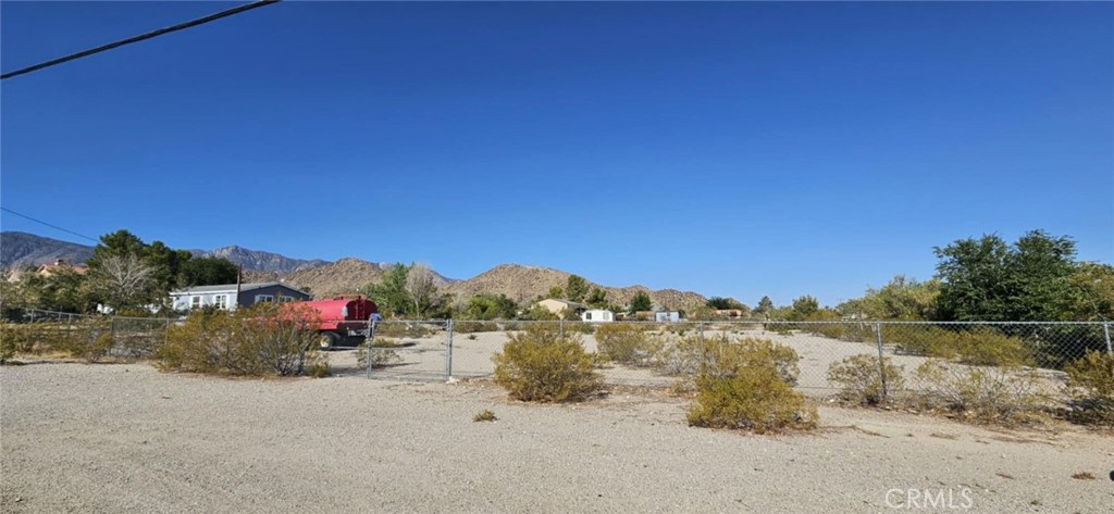 9268 Mesa Road Lucerne Valley, CA 92356 - Photo 3 of 4 a view of a road with a building in the background