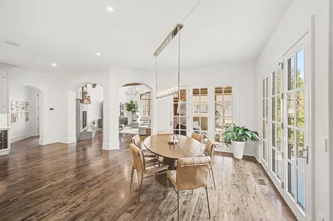 a large white kitchen with a large window