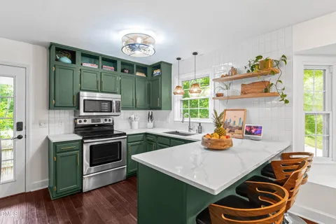 a kitchen view with living room dining table and chairs