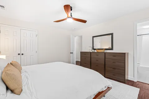 a bedroom with a bed and a dresser