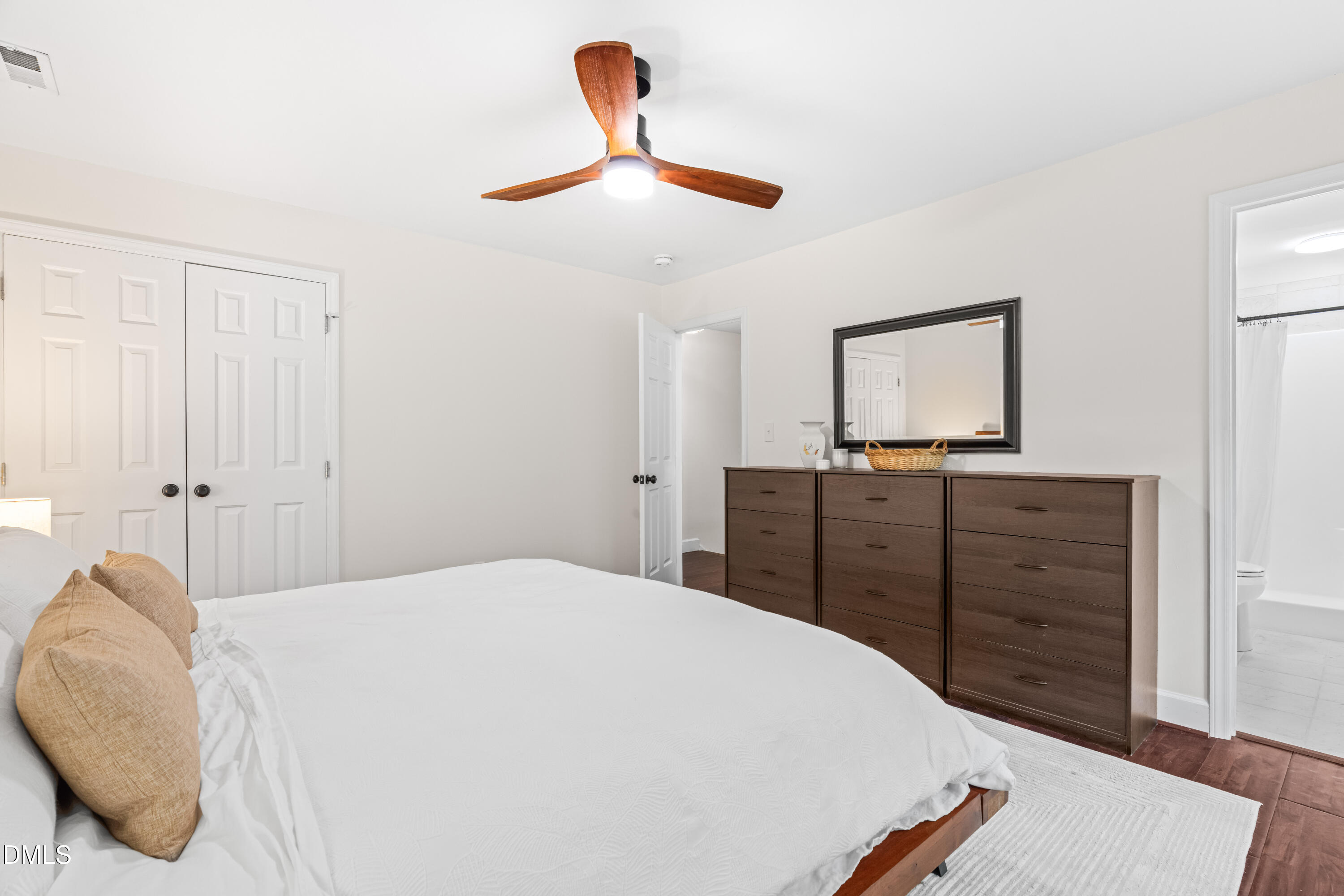1109 Theresa Court Raleigh, NC 27615 - Photo 16 of 39 a bedroom with a bed and a dresser