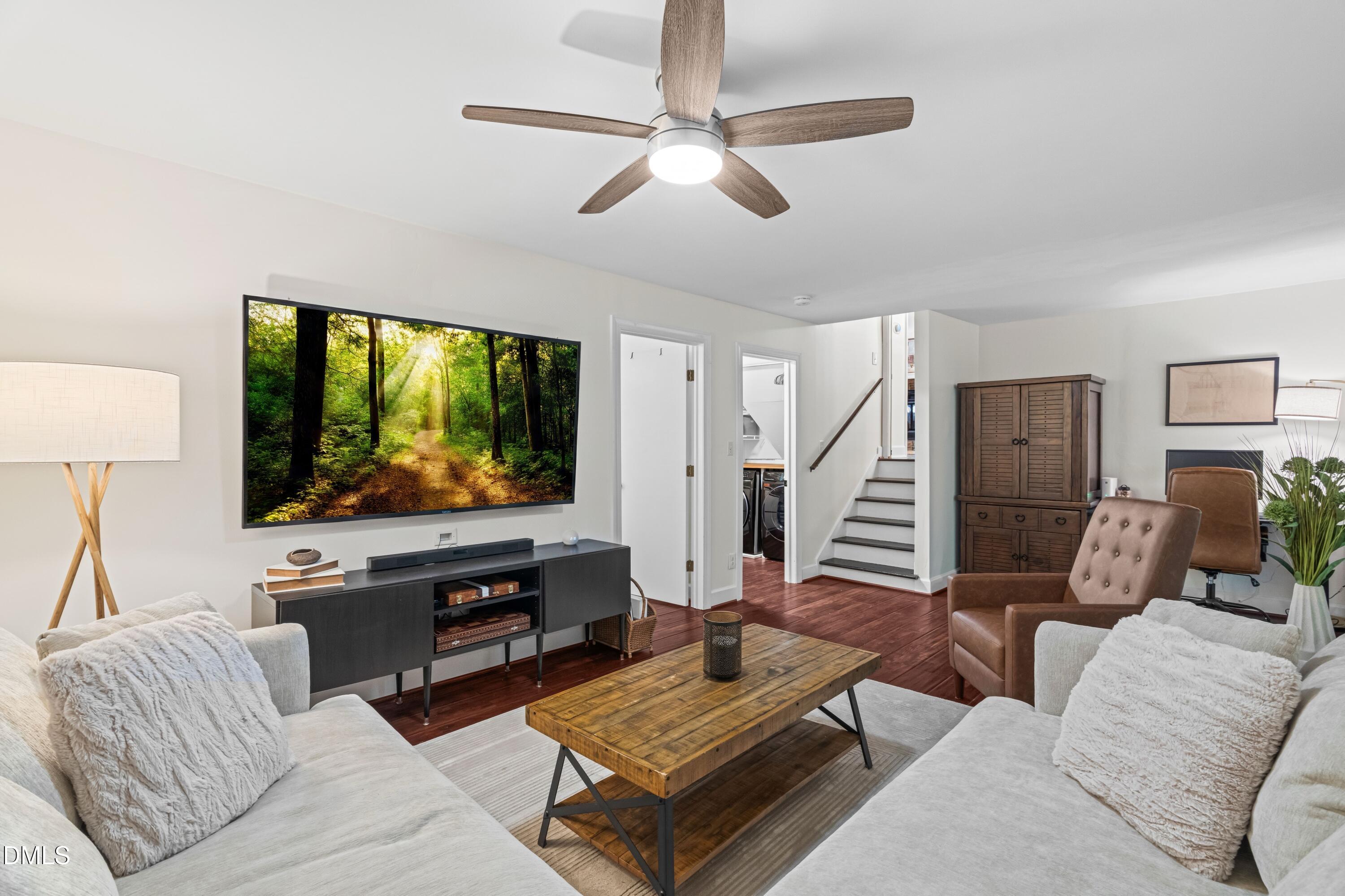 1109 Theresa Court Raleigh, NC 27615 - Photo 23 of 39 a living room with furniture and a flat screen tv