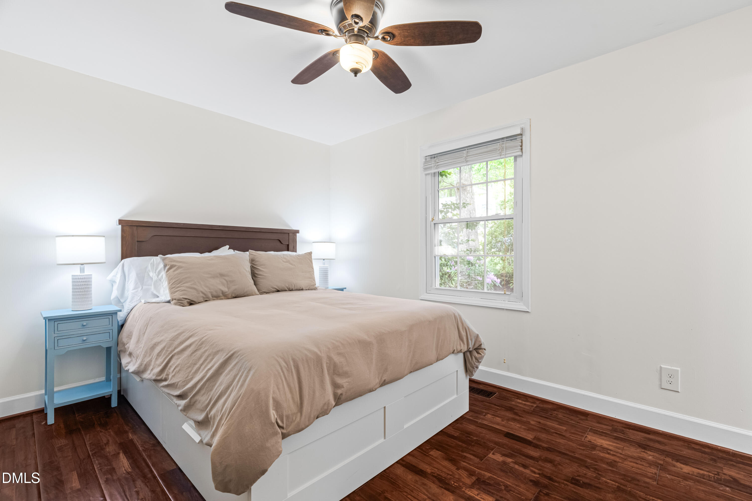 1109 Theresa Court Raleigh, NC 27615 - Photo 25 of 39 a bedroom with a bed and wooden floor