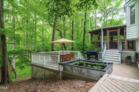 a view of a deck with furniture and a yard