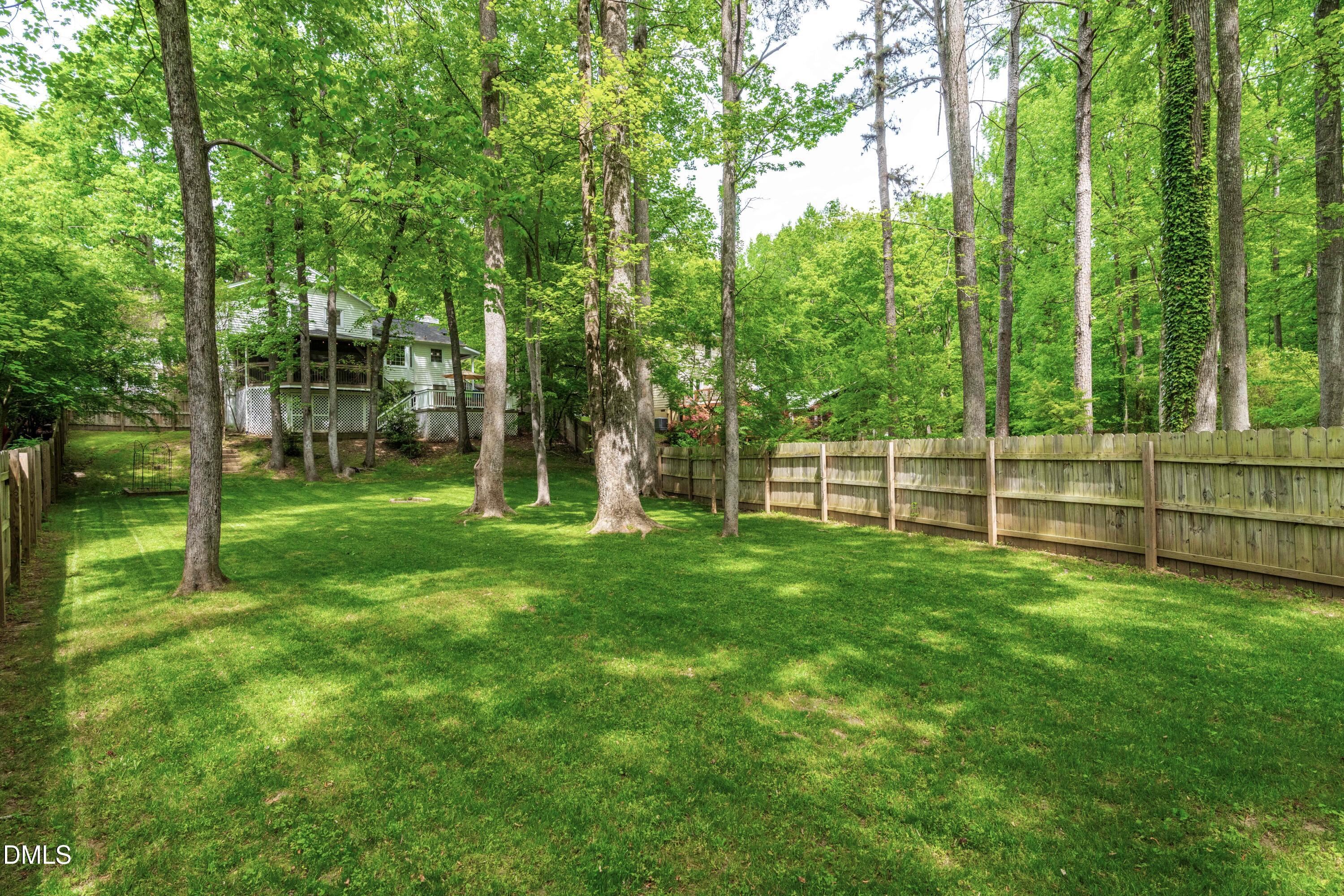 1109 Theresa Court Raleigh, NC 27615 - Photo 35 of 39 a view of a backyard with a garden and trees