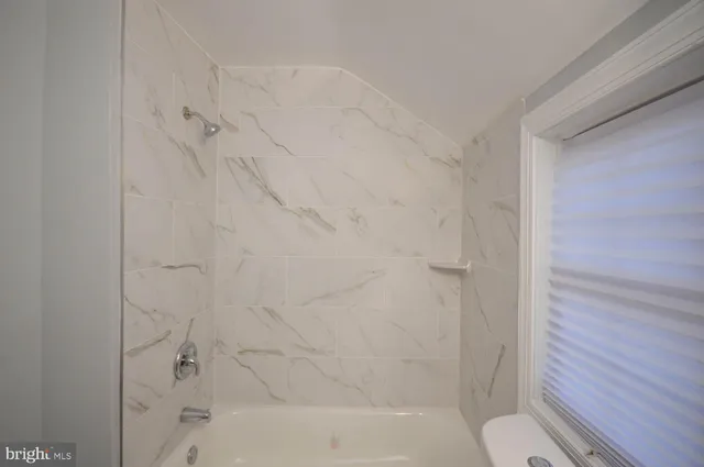 a bathroom with a bathtub and shower