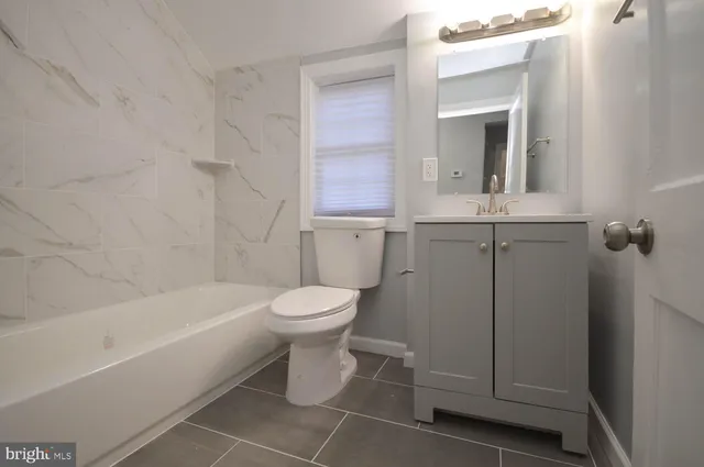 a bathroom with a toilet sink and bathtub