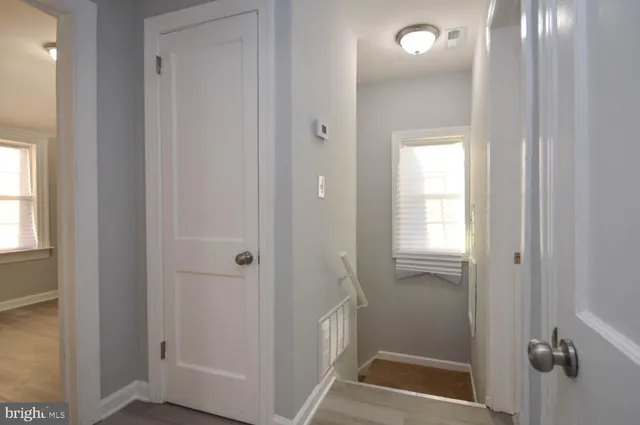a view of a bathroom from a hallway