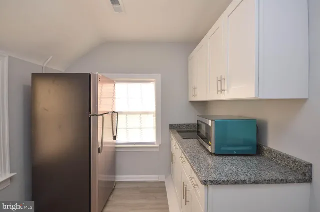 a kitchen with granite countertop white cabinets and a granite counter tops