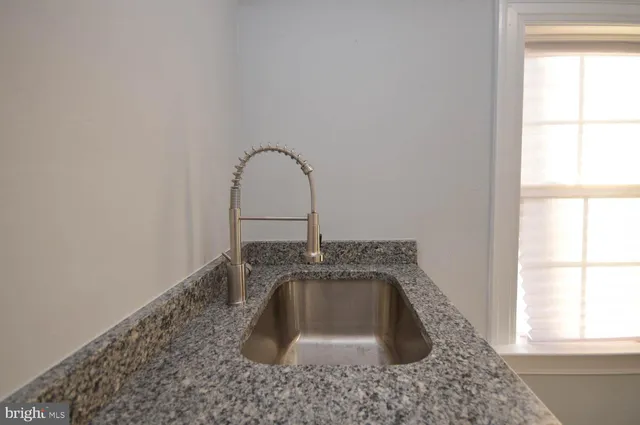 a close view of sink a vanity and window in a room