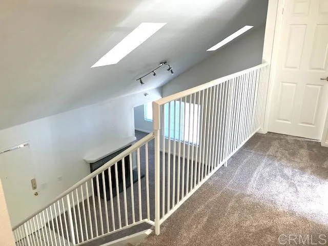 a view of a hallway with stairs