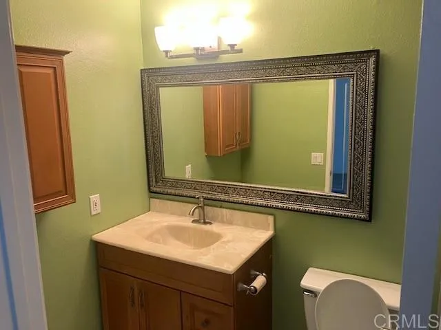 a bathroom with a sink a mirror and a toilet
