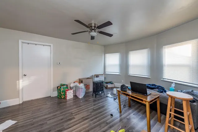 a work room with furniture and wooden floor