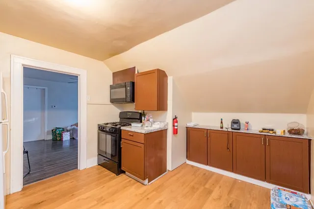 a kitchen with kitchen island cabinets and wooden floor