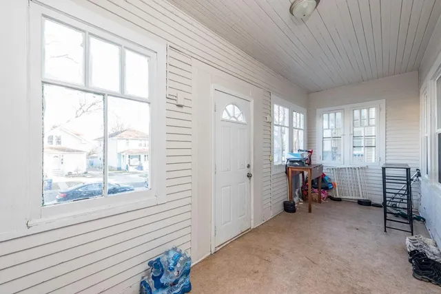 a view of a room with furniture and windows