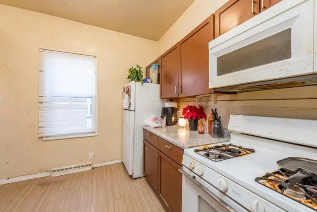 a kitchen with a stove and a refrigerator