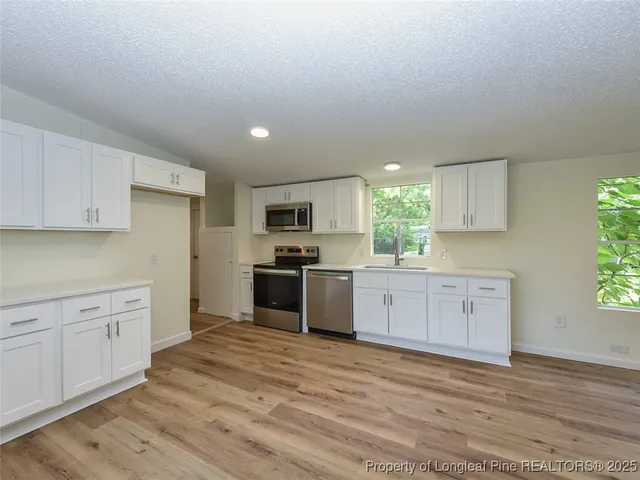 a view of a green field with sitting area
