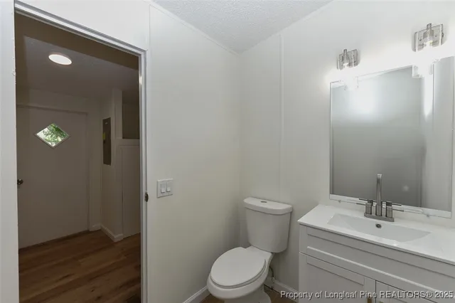 a view of an empty room with a fireplace and a window