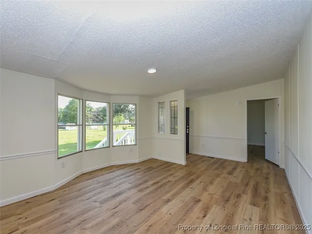 an empty room with wooden floor and closet