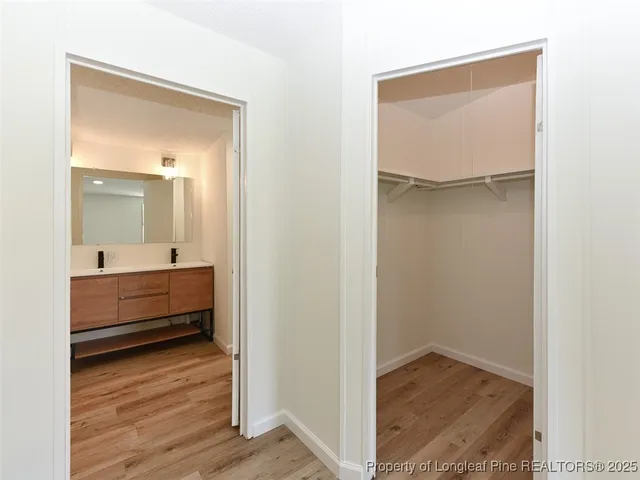 a backyard of a house with plants and large tree