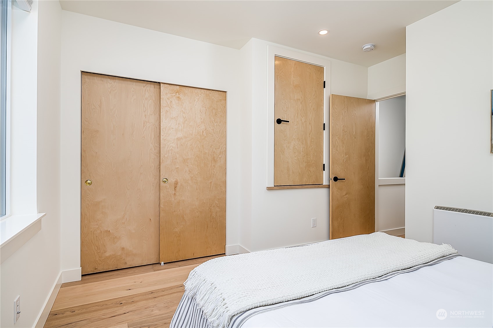 916 North 100th Street, Unit B Seattle, WA 98133 - Photo 11 of 19 a bedroom with a bed and a shower