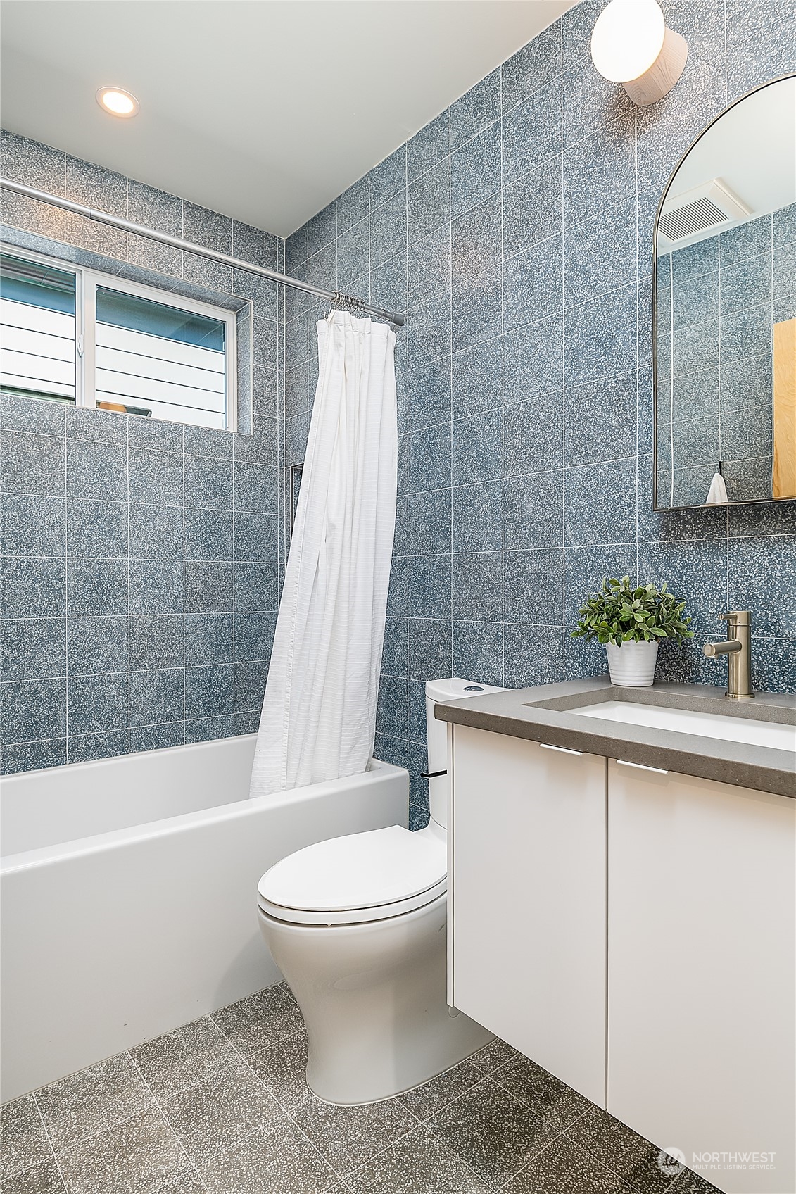 916 North 100th Street, Unit B Seattle, WA 98133 - Photo 13 of 19 a bathroom with a sink a toilet and bathtub