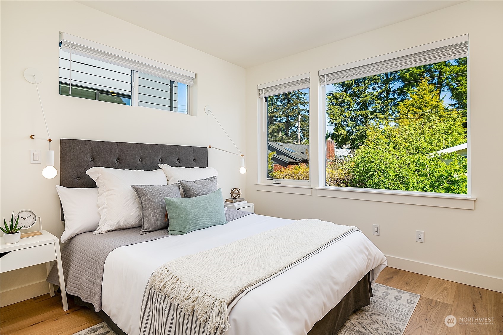 916 North 100th Street, Unit B Seattle, WA 98133 - Photo 10 of 19 a bedroom with a large bed and a window