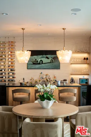 a view of a dining table chairs and chandelier