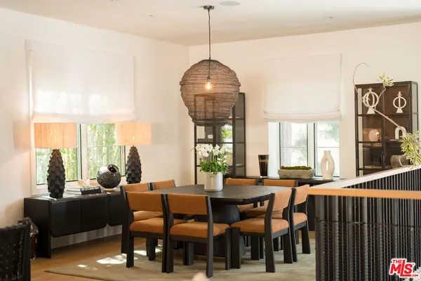 a living room with furniture a window and a chandelier