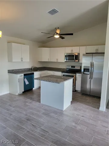 a kitchen with stainless steel appliances granite countertop a stove and a sink