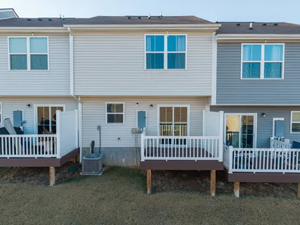 a view of a house with a deck and a yard