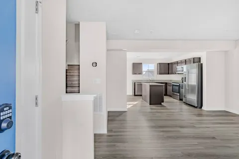 a view of a kitchen with a refrigerator a stove top oven