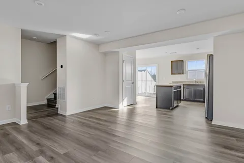 a view of a kitchen with a sink a kitchen a refrigerator and a stove top oven