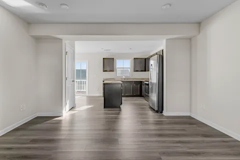 a view of kitchen with cabinets microwave and stove