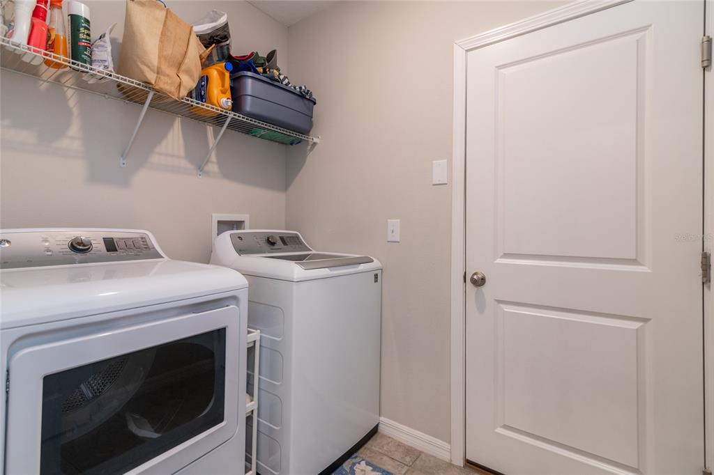 5127 Sable Chime Drive Wimauma, FL 33598 - Photo 13 of 56 a utility room with dryer and washer