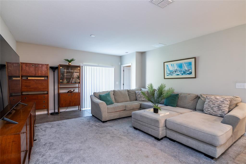 5127 Sable Chime Drive Wimauma, FL 33598 - Photo 14 of 56 a living room with furniture and storage area