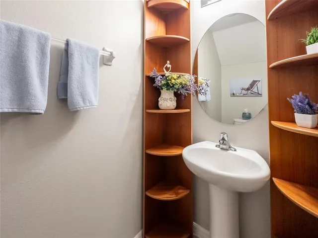 a bathroom with a sink toilet and mirror