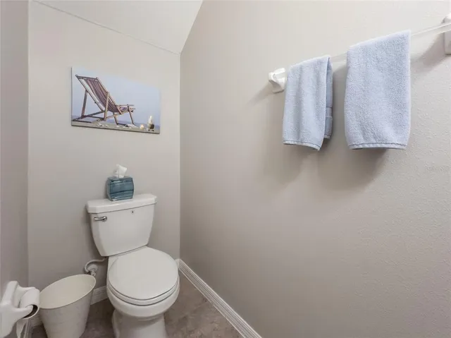 a white toilet sitting next to a white sink