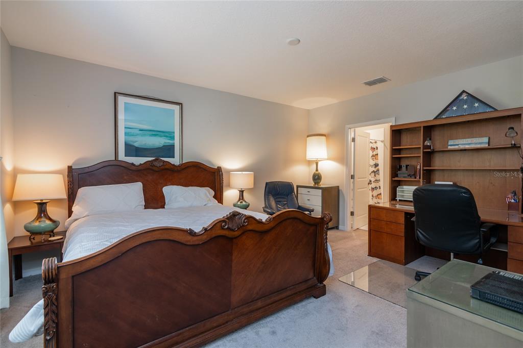 5127 Sable Chime Drive Wimauma, FL 33598 - Photo 20 of 56 a bedroom with a bed and lamp