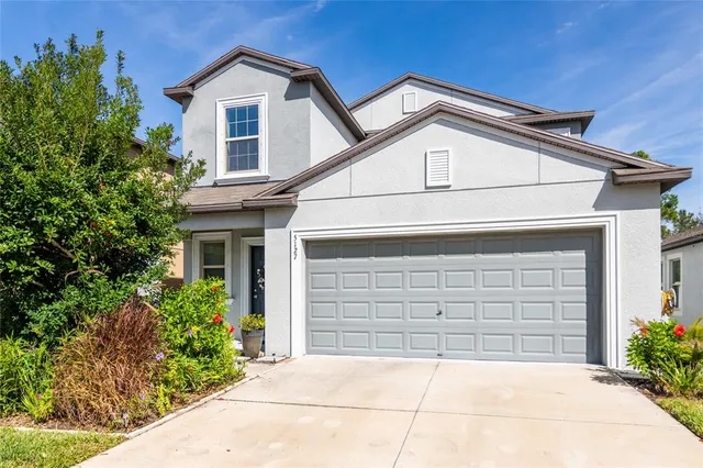 a front view of a house with garage