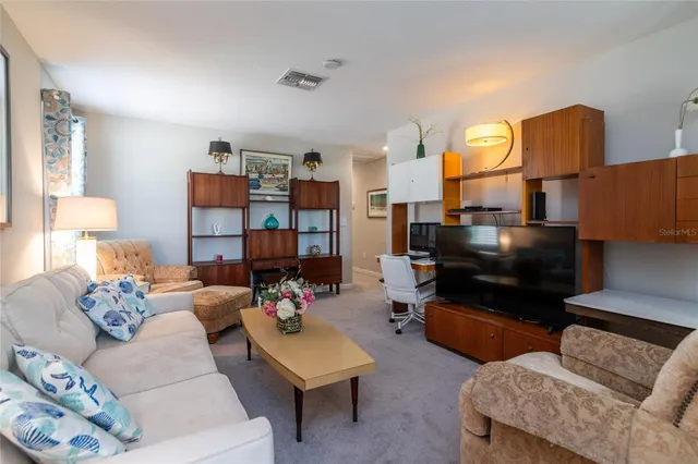 a living room with furniture and a lamp