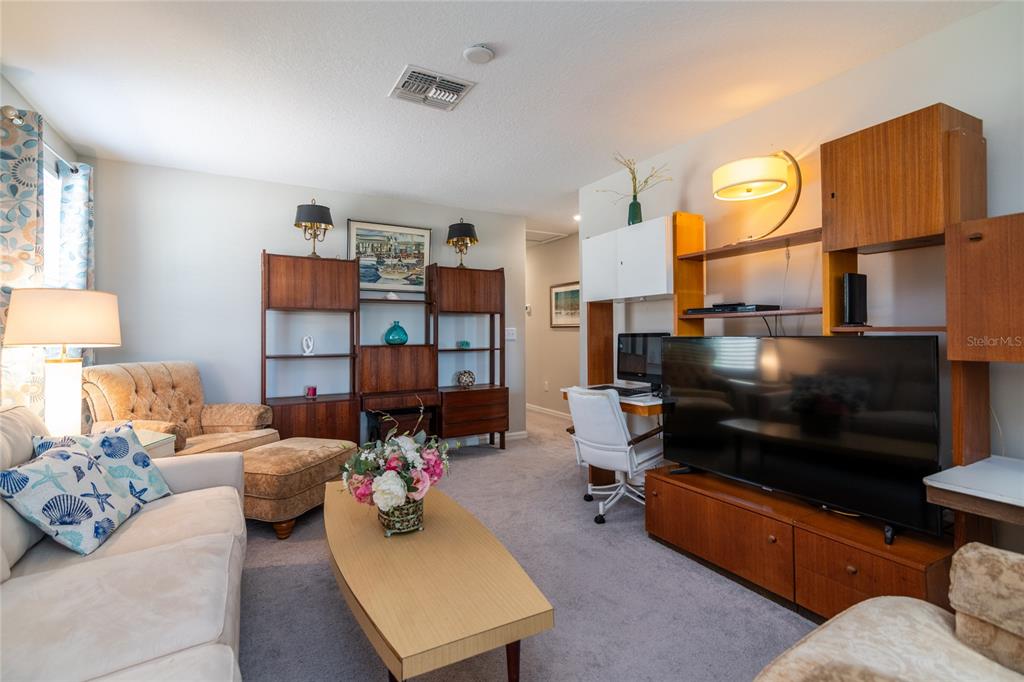 5127 Sable Chime Drive Wimauma, FL 33598 - Photo 27 of 56 a living room with furniture and a lamp