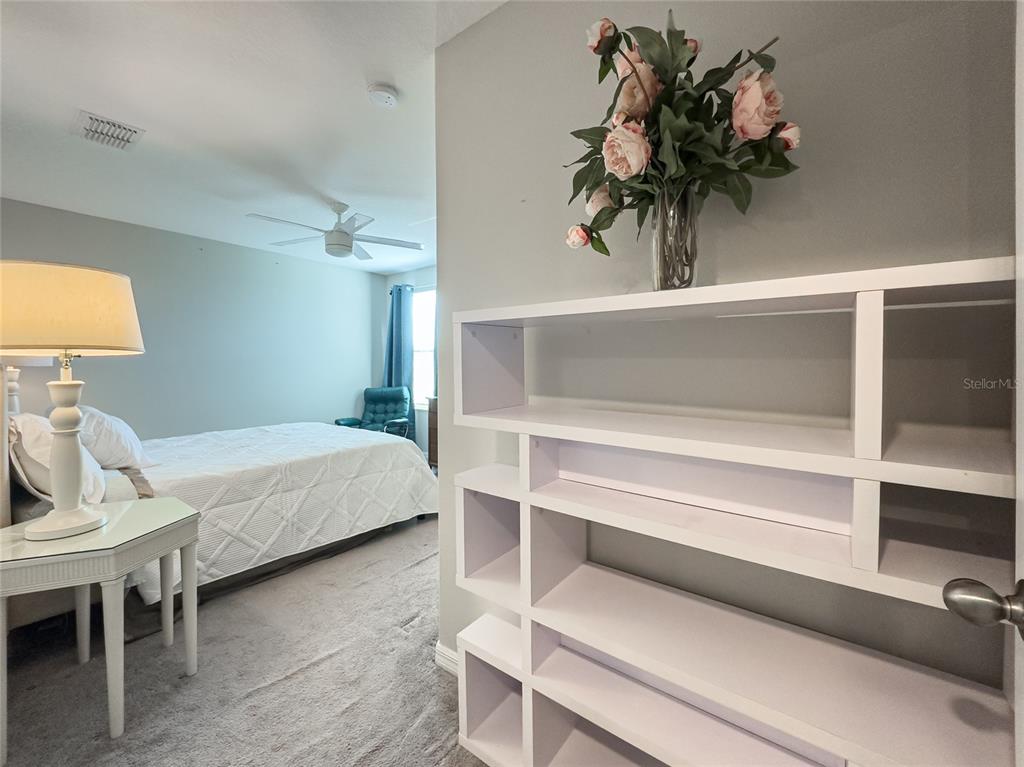 5127 Sable Chime Drive Wimauma, FL 33598 - Photo 29 of 56 a bedroom with a bed and a potted plant