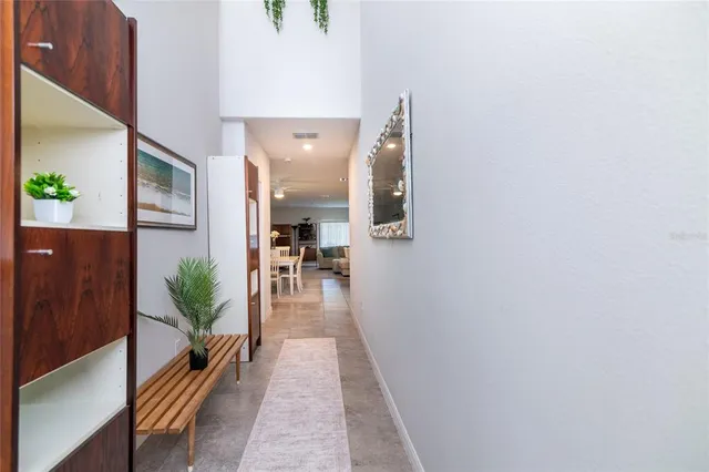 a hallway with view of living room with furniture
