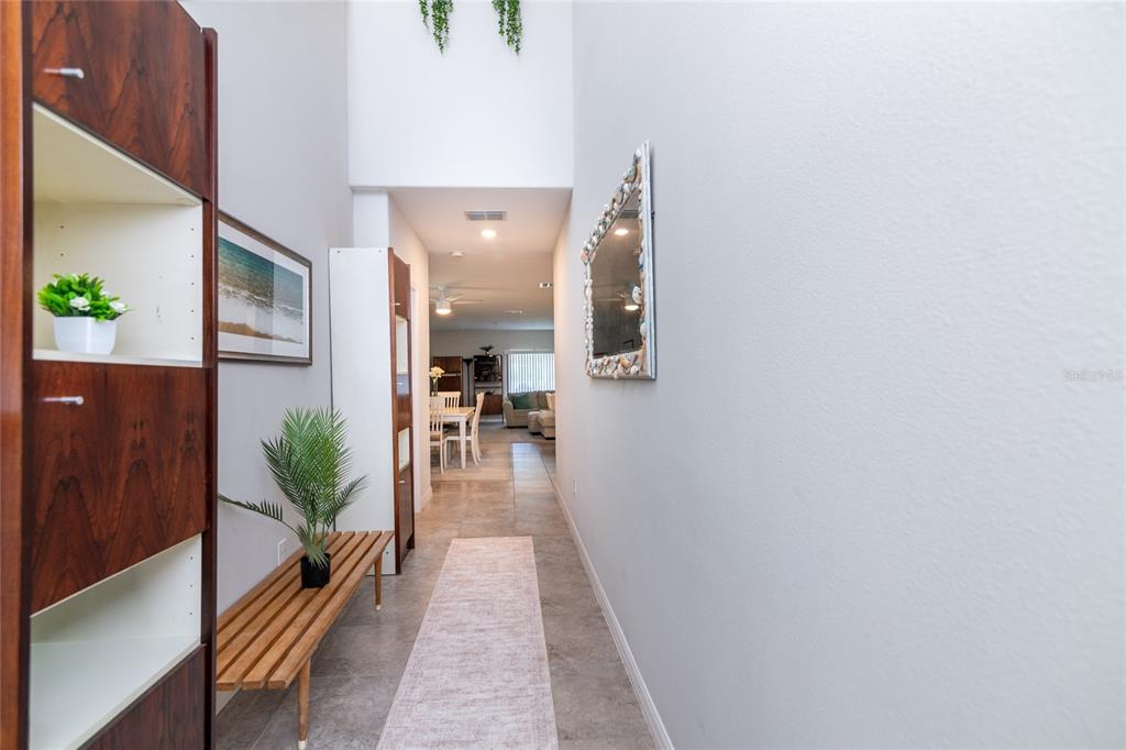 5127 Sable Chime Drive Wimauma, FL 33598 - Photo 3 of 56 a hallway with view of living room with furniture