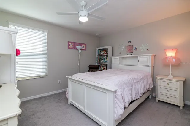 a bedroom with a bed and a desk