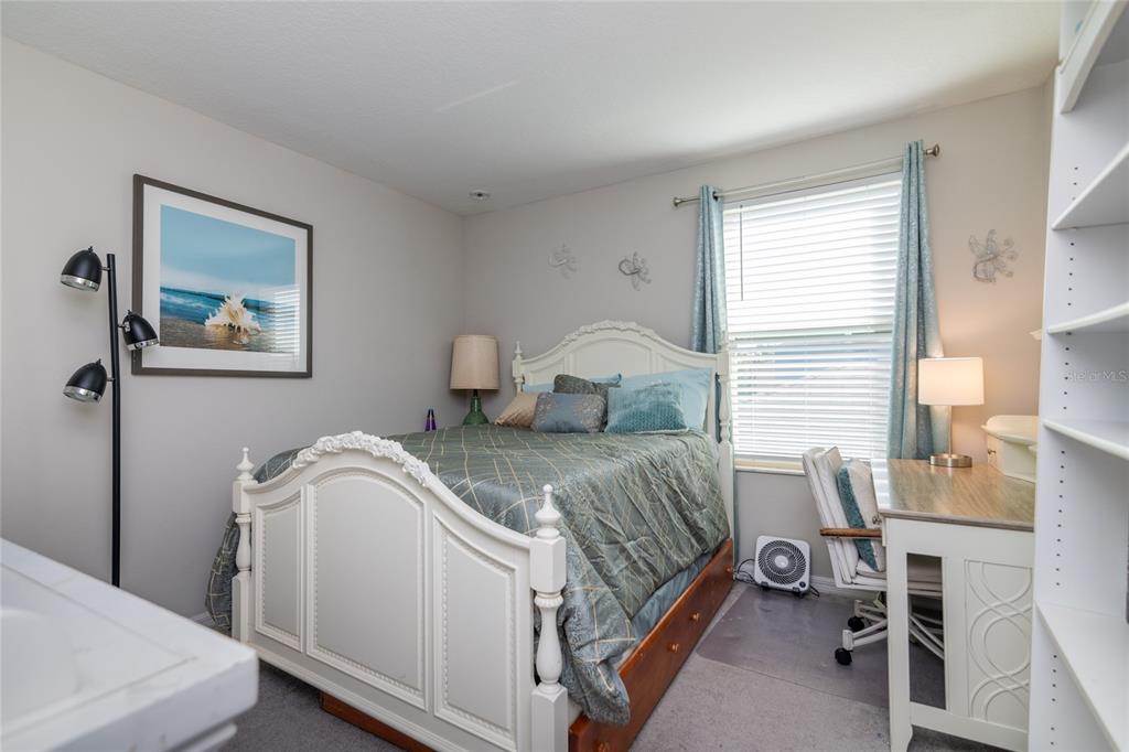 5127 Sable Chime Drive Wimauma, FL 33598 - Photo 35 of 56 a bedroom with a bed and a desk